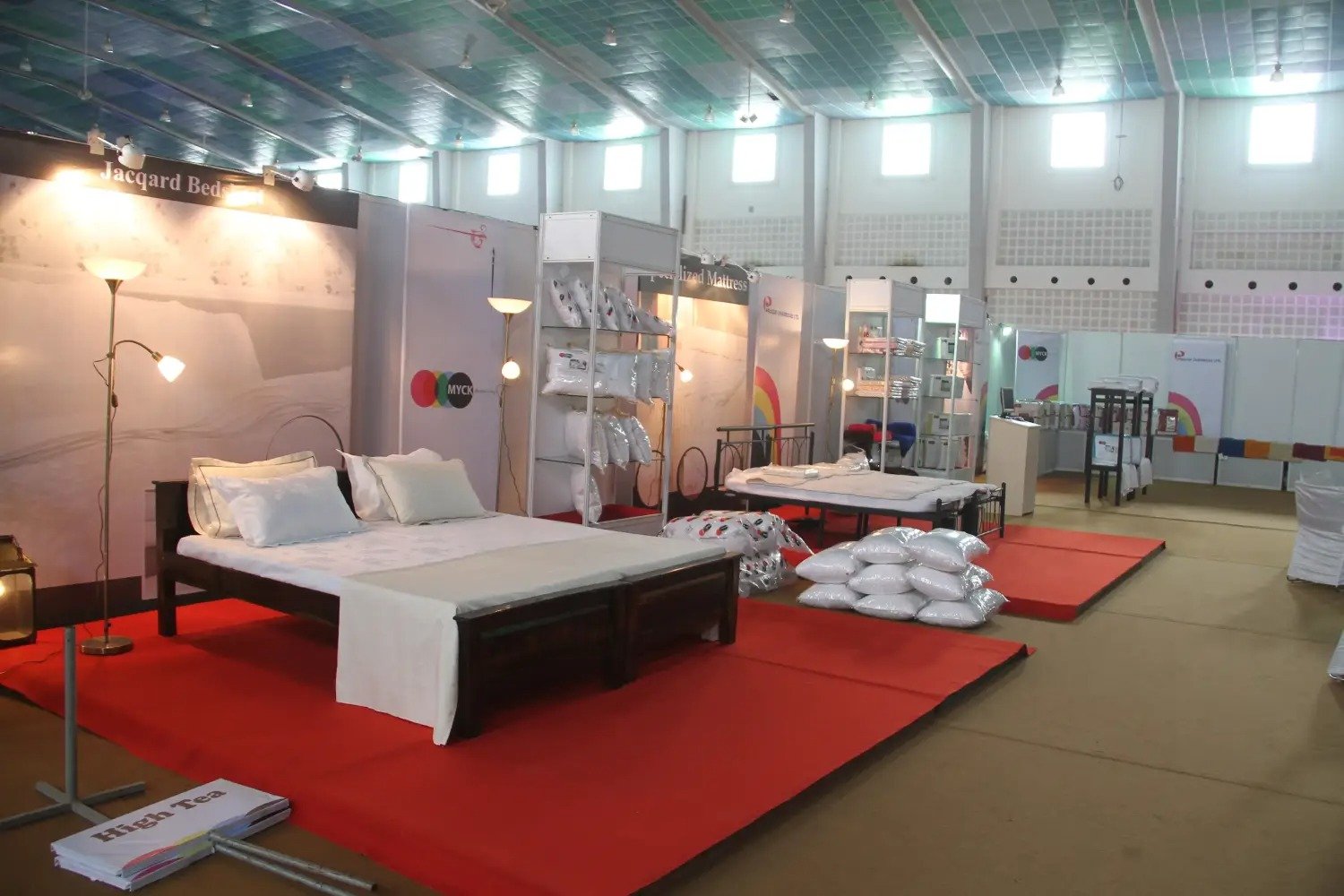 Man and woman speaking on stage at night with blue lighting